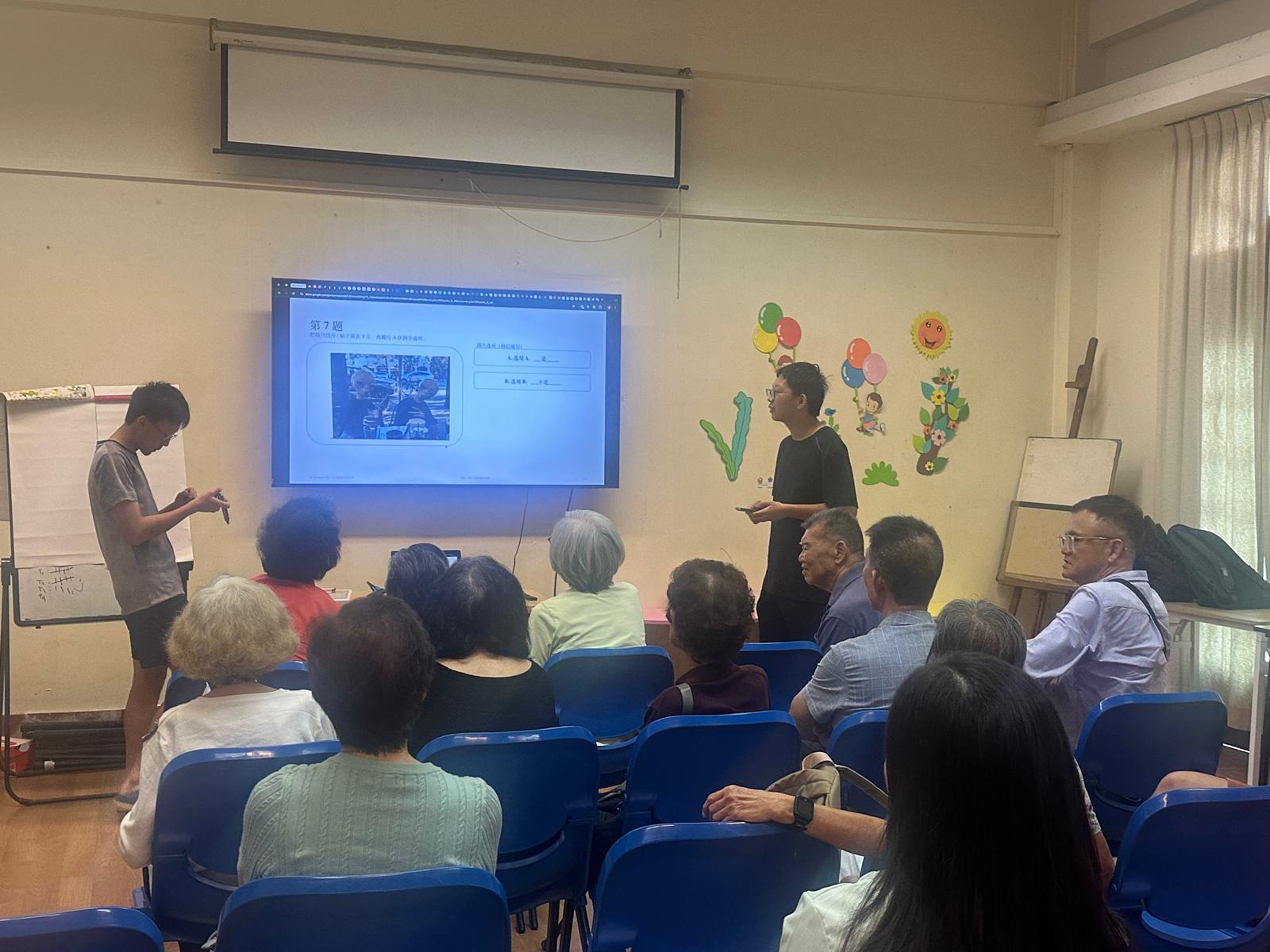 AI Awareness SG facilitators presenting an activity to community participants